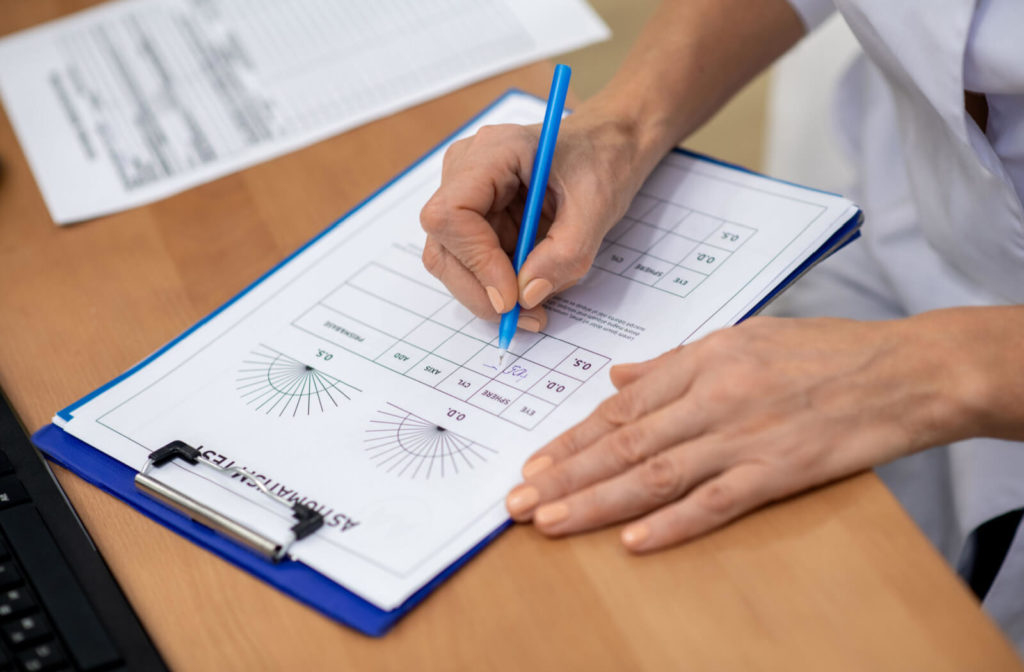 An optometrist is writing a new prescription for a patient with an expired prescription.