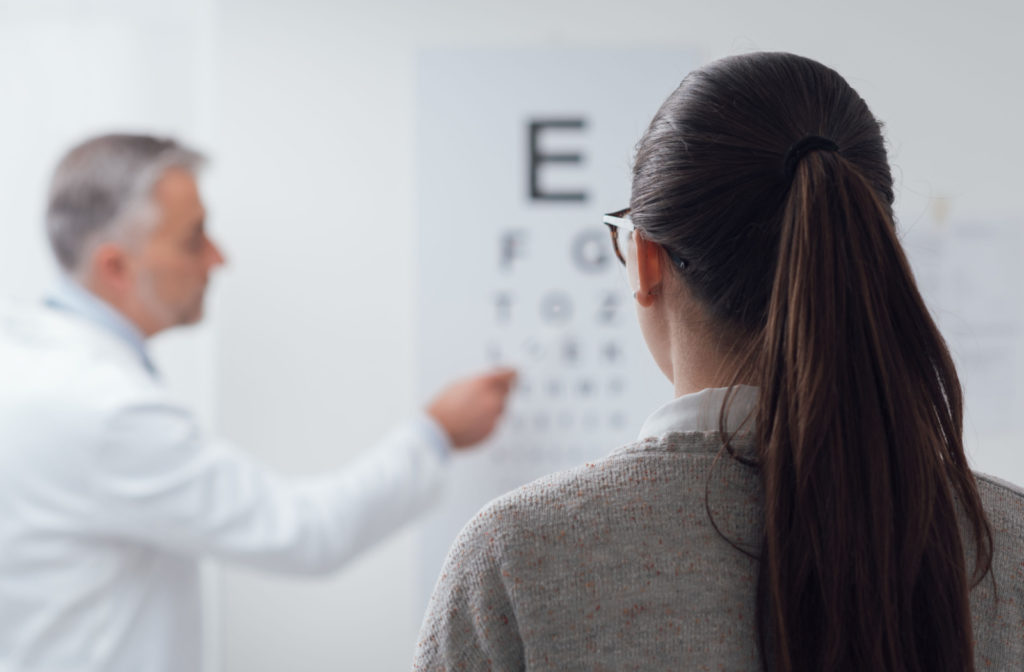 A patient reading an eye chart to test visual acuity
