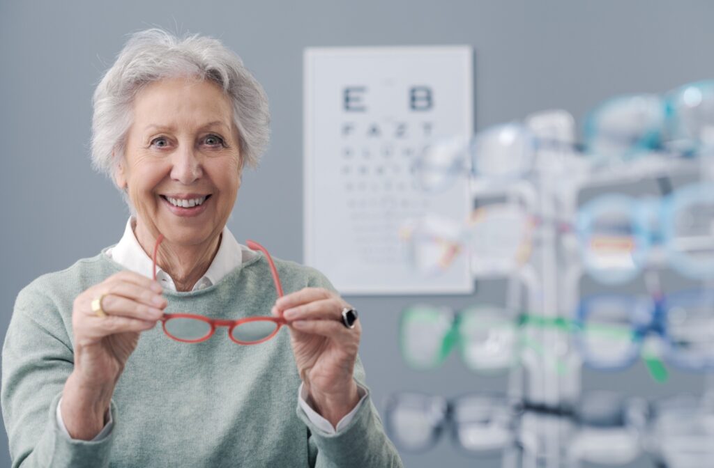 An older woman is at her eye care professionals office for her annual eye exam, which is covered by her health insurance.