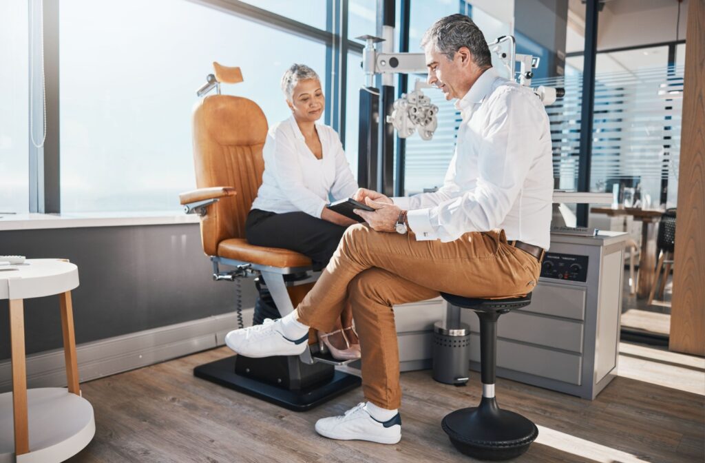 An eye doctor discusses their patient's symptoms with them to determine if they have an ocular surface disease.