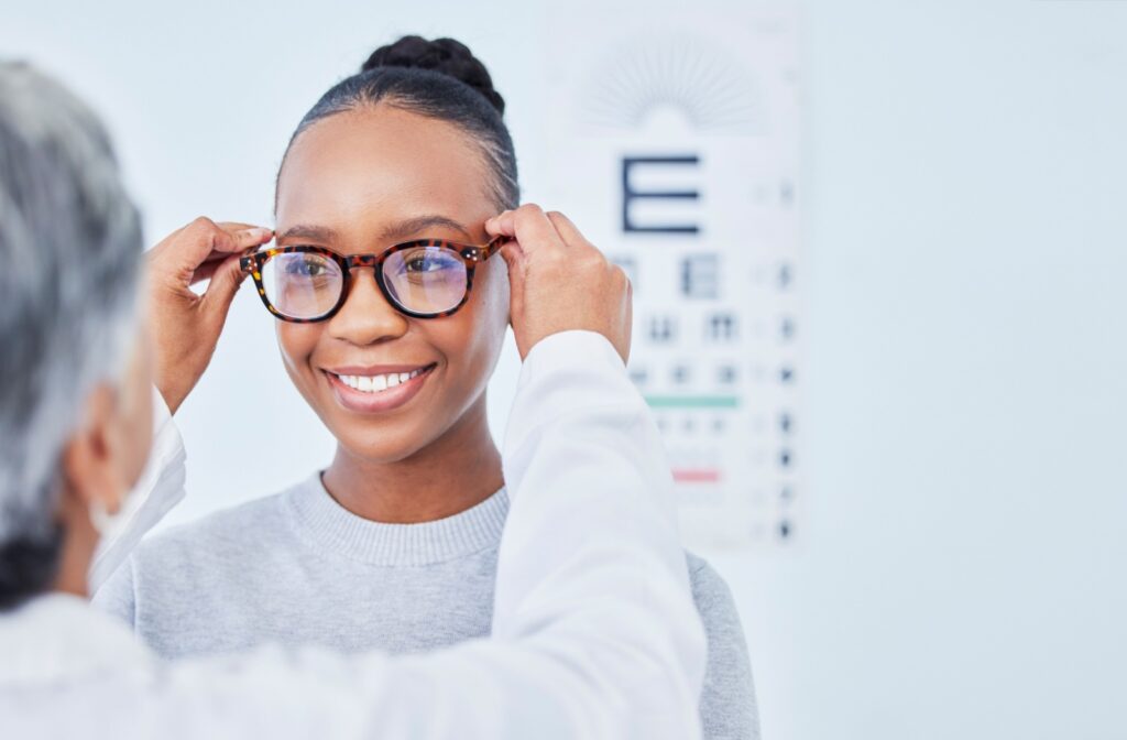 A person trying on glasses at the eye doctor's office