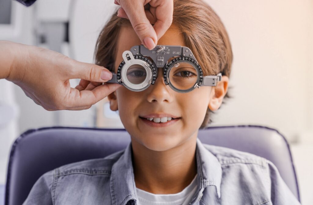 A young kid getting their eyes examined by an eye doctor to monitor for progression of myopia.