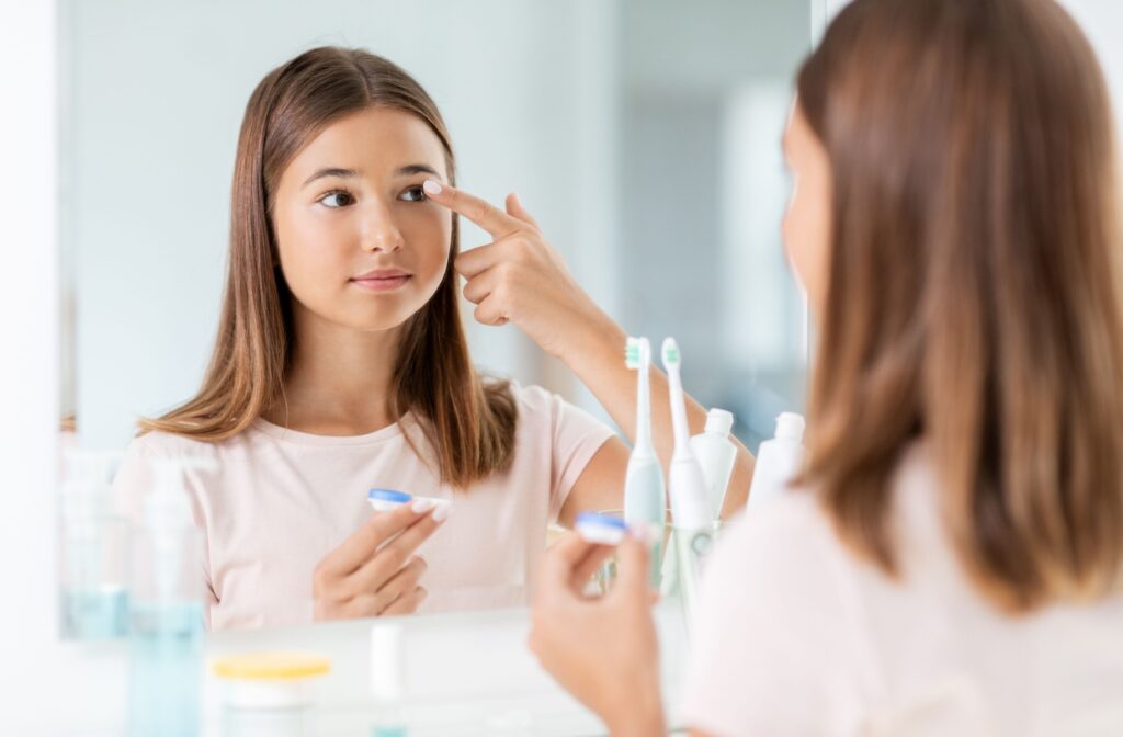 A kid putting in specialized contact lenses for myopia control.